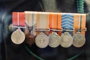 Ex-Servicemen Reservation Quota eligibility shown through military service medals worn by retired Indian Army soldier on civil dress.